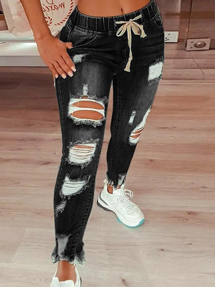 Pantaloni in denim stile street con coulisse, effetto usurato e vestibilità comoda
